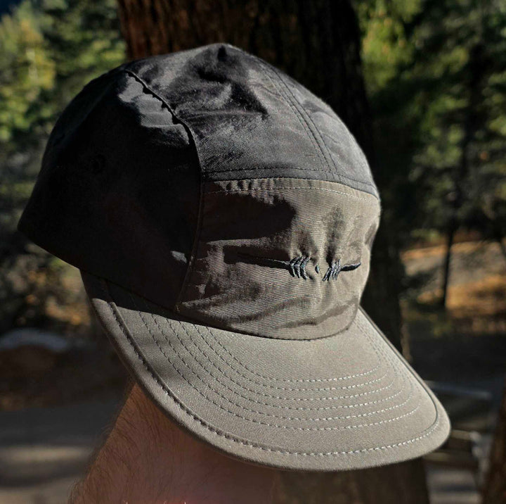 Gray cap with a logo on a blurred natural background